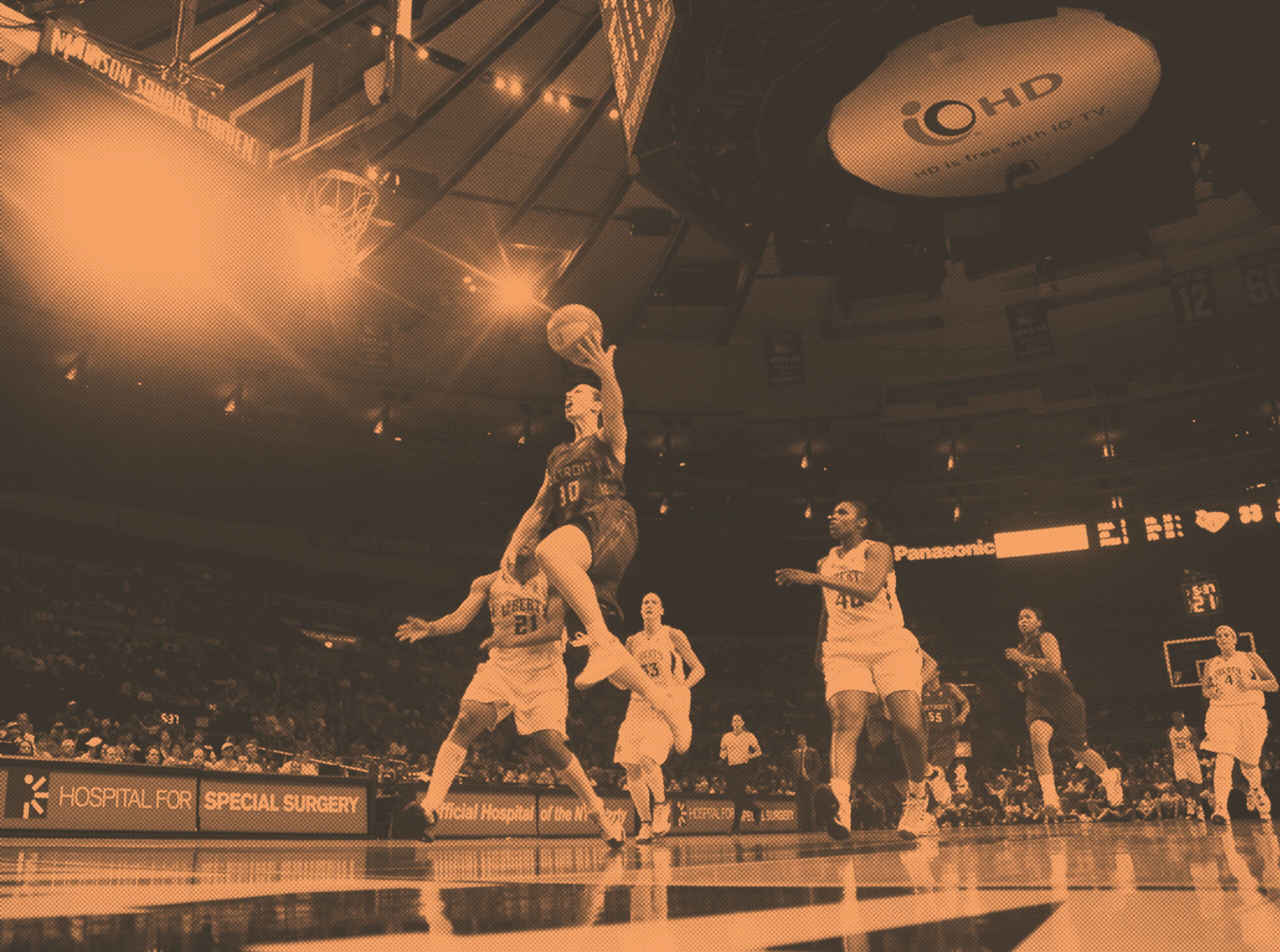 Katie Smith in a mid-air jump on the court during the New York Liberty vs. Detroit Shock WNBA game. 